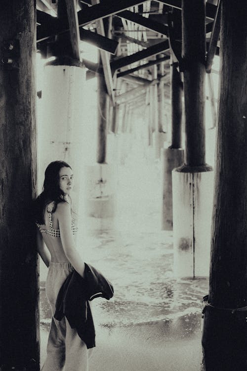 Woman in Bra Standing Under a Bridge