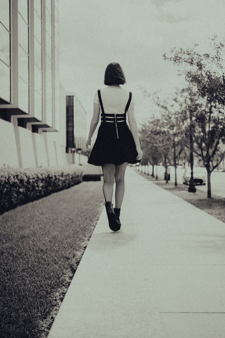 Woman In Dress Walking Pavement