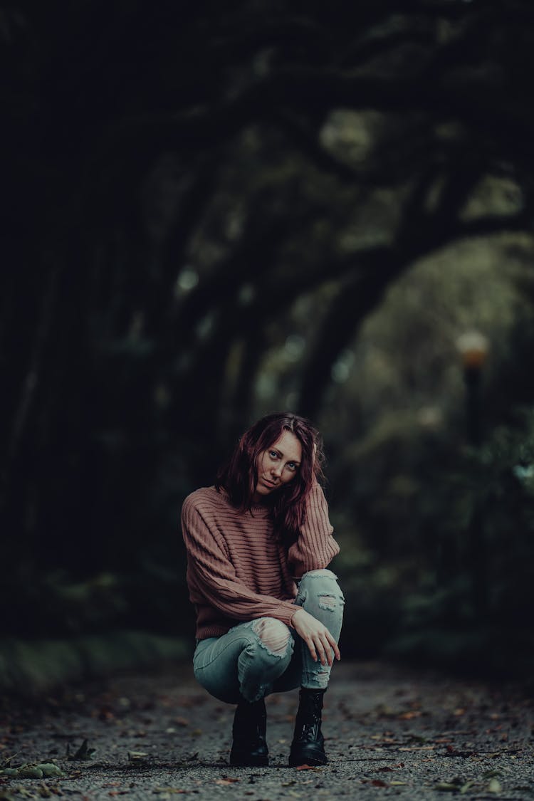 Woman Sitting Posing In Park