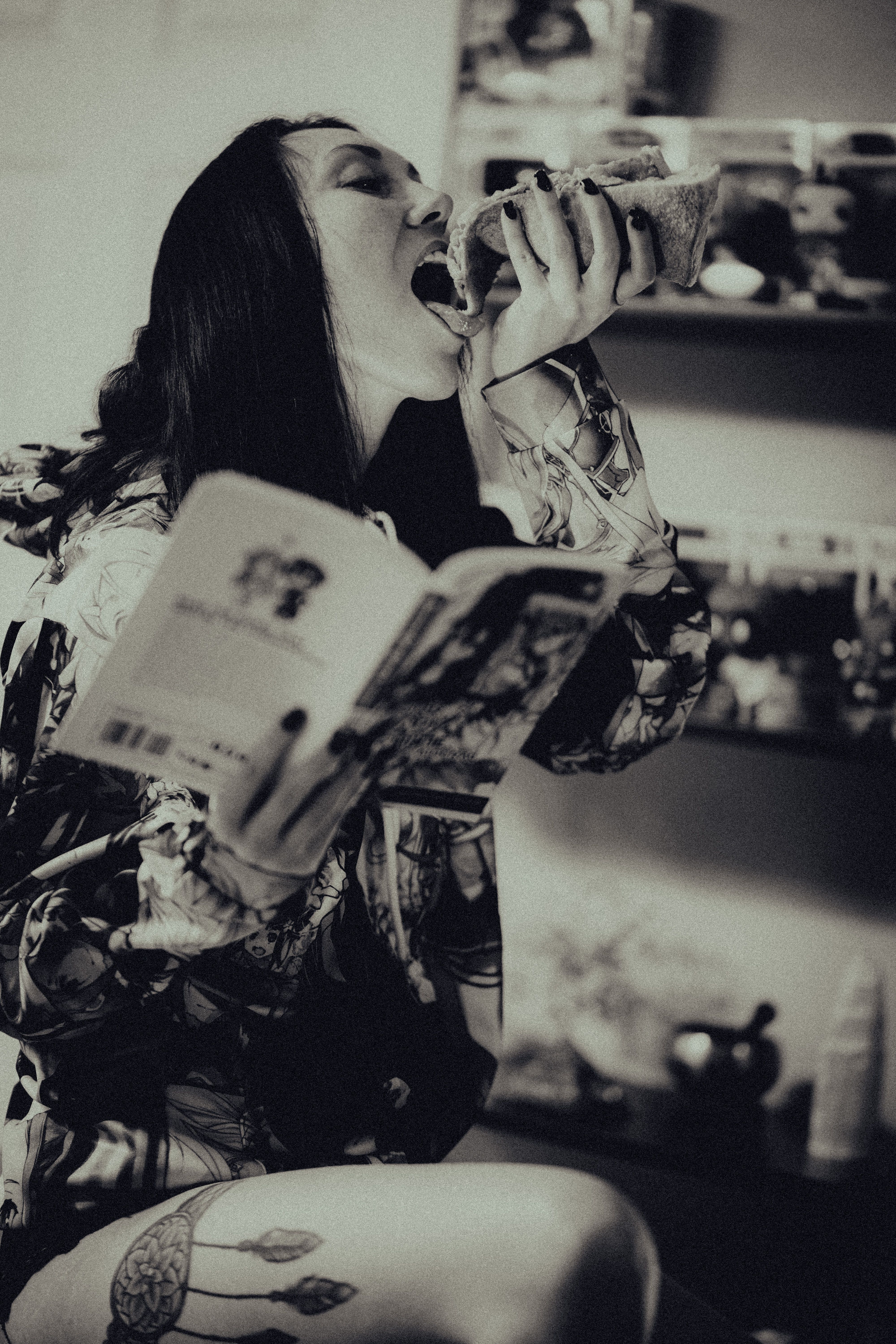 Woman Eating and Reading Book Indoors · Free Stock Photo