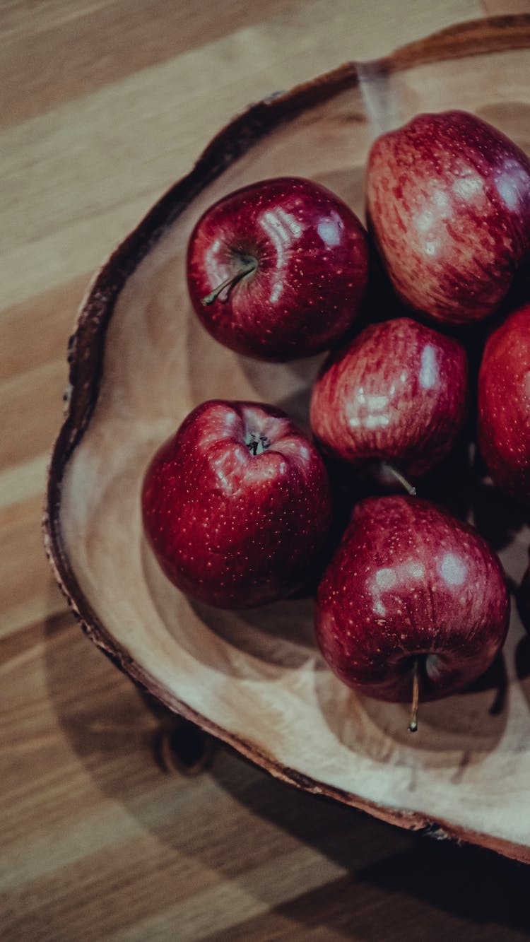 Delicious Red Apples In Brown Wooden Board