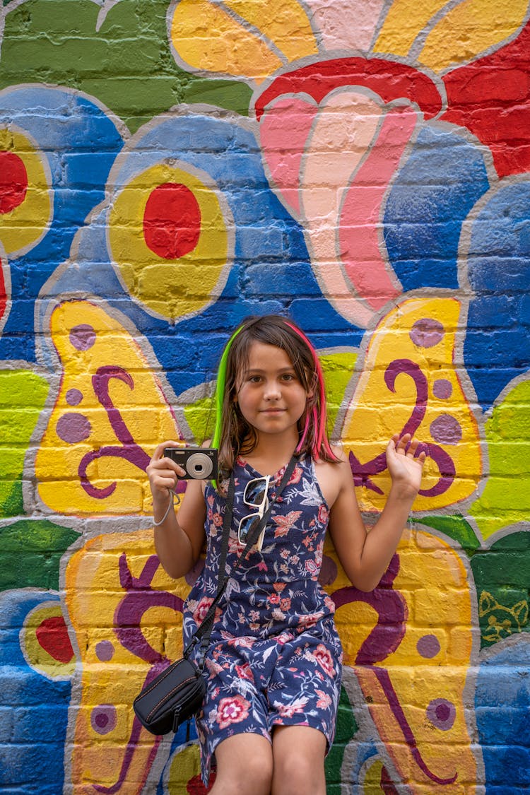 Photo Of A Girl In Front Of A Mural 