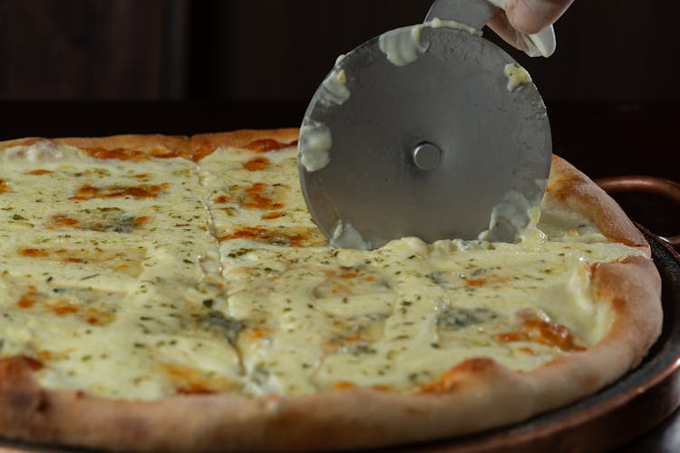 Slicing Pizza With Cheese On Top