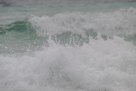 Capture of ocean waves crashing with foam and spray, depicting the sea's dynamic nature.
