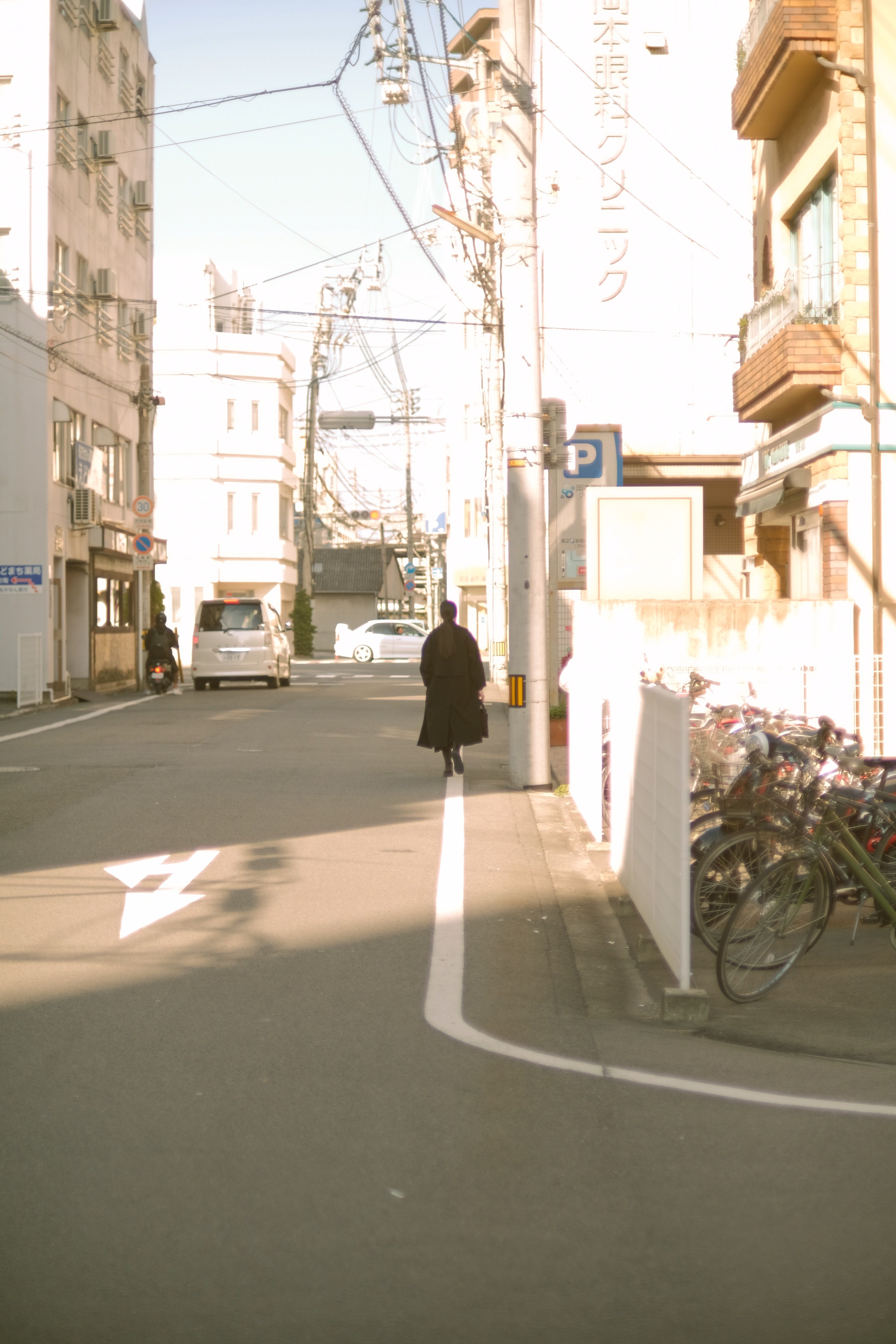 A Woman in Black Coat Walking on Sidewalk · Free Stock Photo