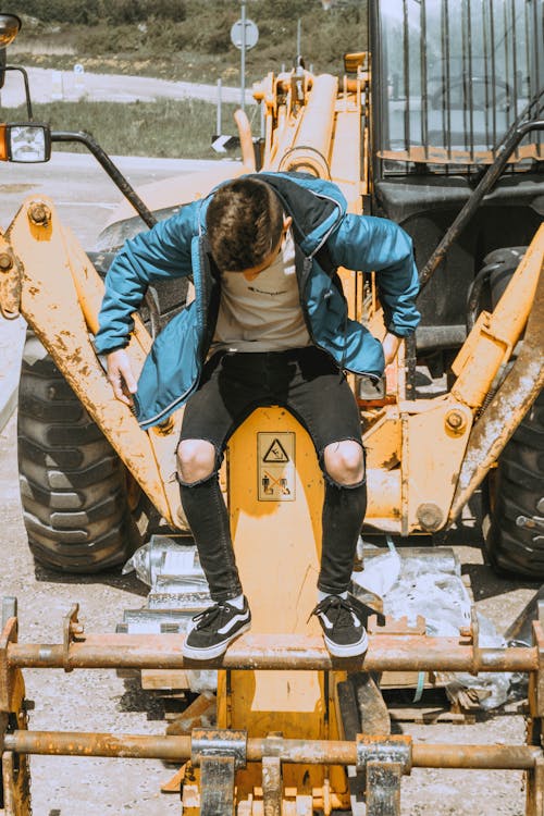 Man About to Stand on Heavy Equipment