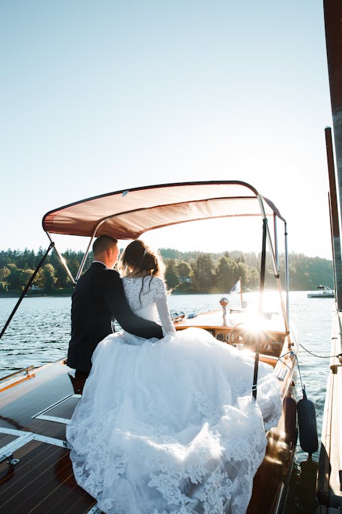 Wedded Couple Sitting on Motorboat