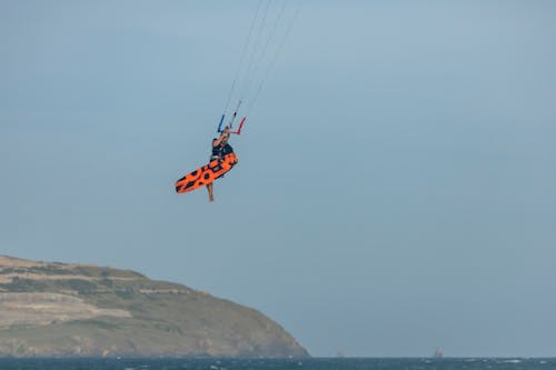 A Man Kitesurfing Midair