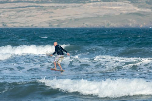 A Man in Shorts Kitesurfing