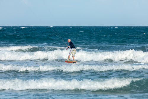 A Man in Shorts Kitesurfing