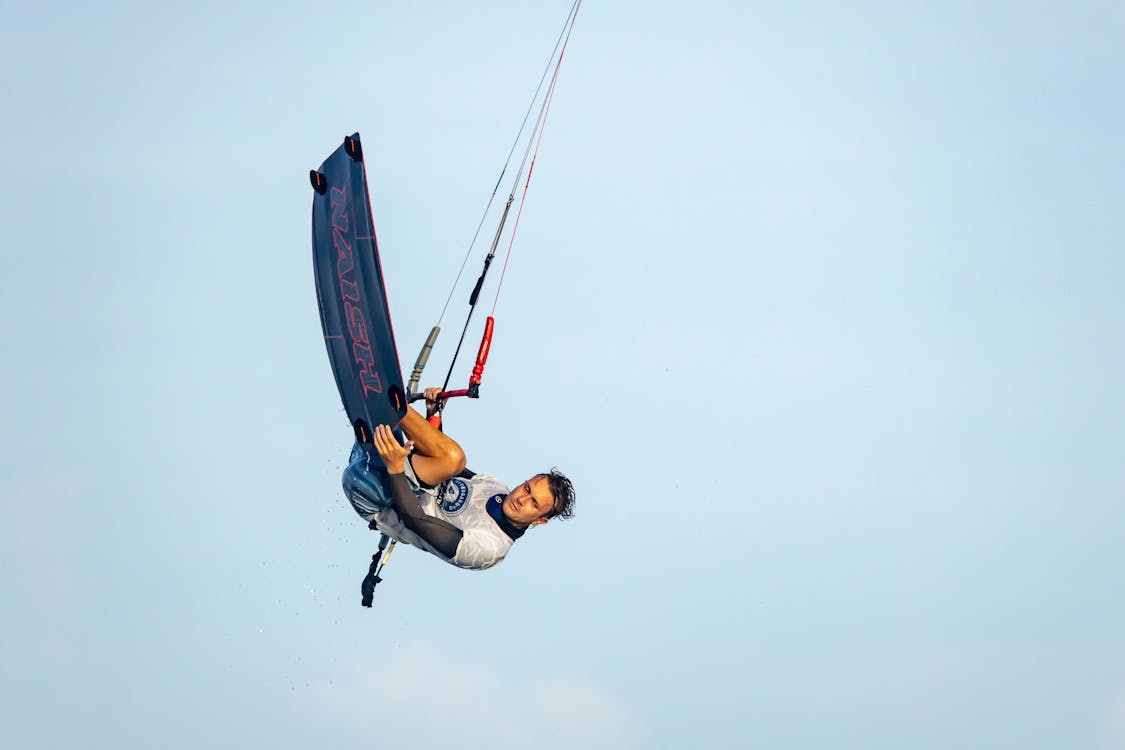 A Man Doing a Kitesurfing Trick Midair