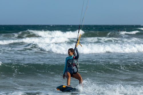 Photo of a Woman Kitesurfing while Smiling