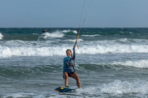 A Woman Smiling while Kitesurfing