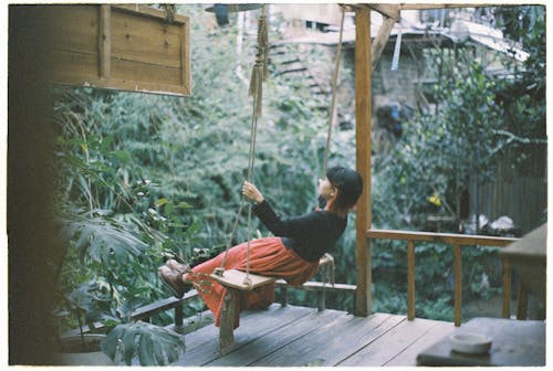 Photo of a Woman Sitting on a Swing