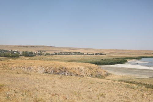 Free Tranquil landscape in Van, Türkiye, showcasing a vast field and a calm shoreline under a clear sky. Stock Photo