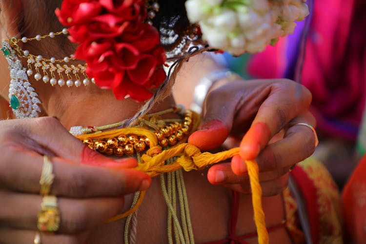 Woman Hands Tying Necklace