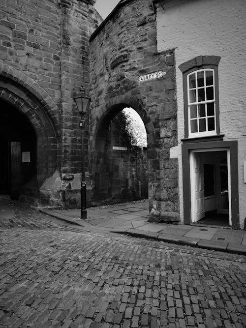 Grayscale Photo of a Brick Building