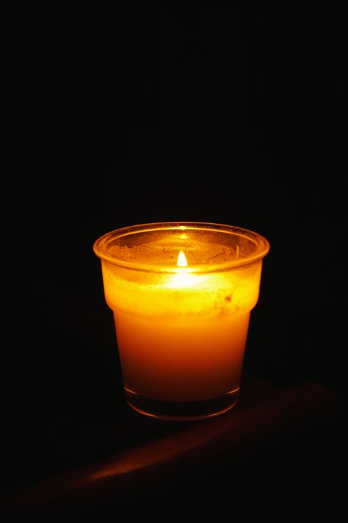 Free A close-up of a lit candle in the dark, creating a warm and soothing atmosphere. Stock Photo