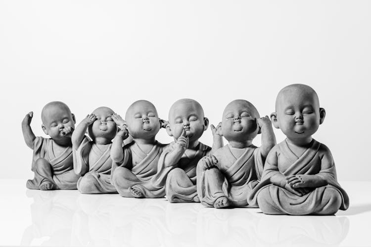 A Grayscale Of Buddha Statues