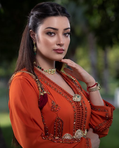 A Woman in Red Dress Wearing Elegant Necklace