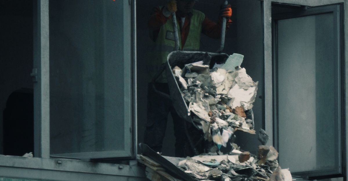 Worker Throwing Trash From Cart On Building Site Free Stock Photo worker-throwing-trash-from-cart-on-building-site-free-stock-photo