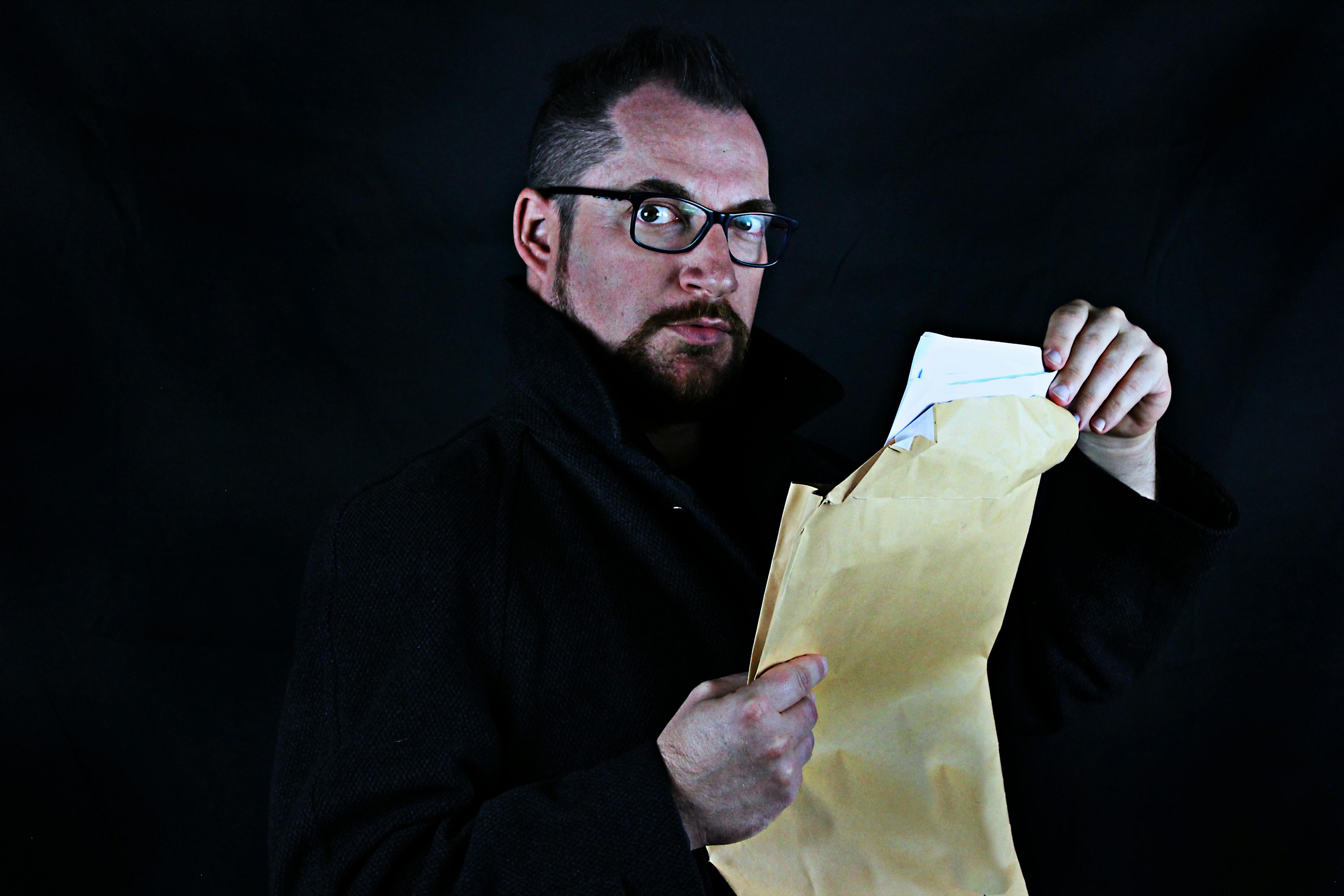 Man Holding Brown Envelope · Free Stock Photo