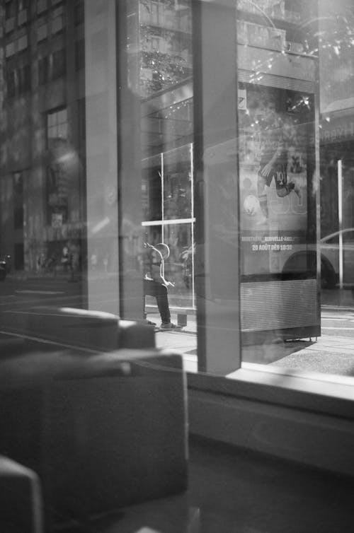 Bus Stop behind Window in Black and White