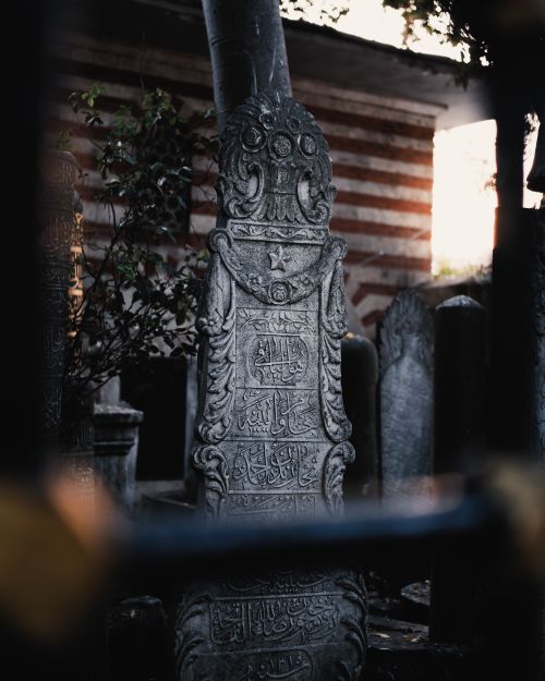Free An intricately carved stone monument in a historical setting at dusk, with rich detail and atmospheric lighting. Stock Photo