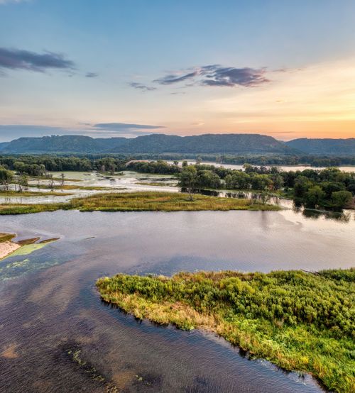Free Peaceful landscape of a water body and greenery at sunset in Kellogg, MN. Stock Photo