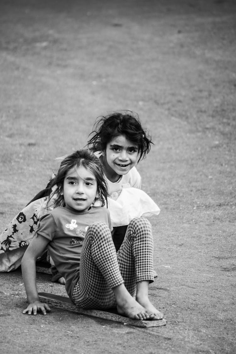 Young Girls Playing With A Plank