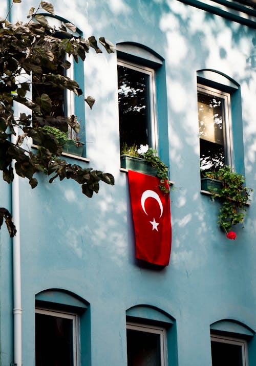 A Turkish Flag Hanging from a Window in an Apartment Building