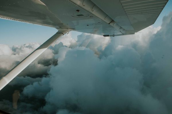 View of a wing above clouds from a small plane — photo by Amar Preciado on Pexels