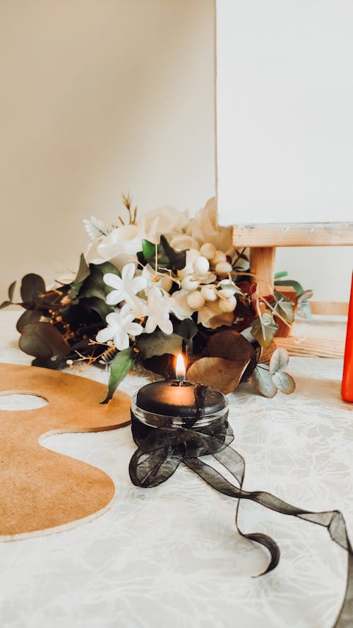 Free Close up of a Candle and Flowers  Stock Photo