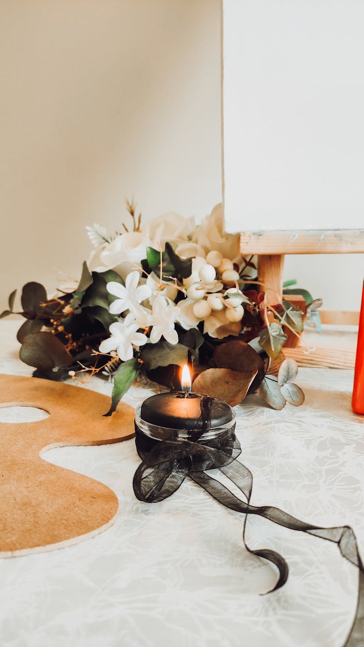 Close Up Of A Candle And Flowers 