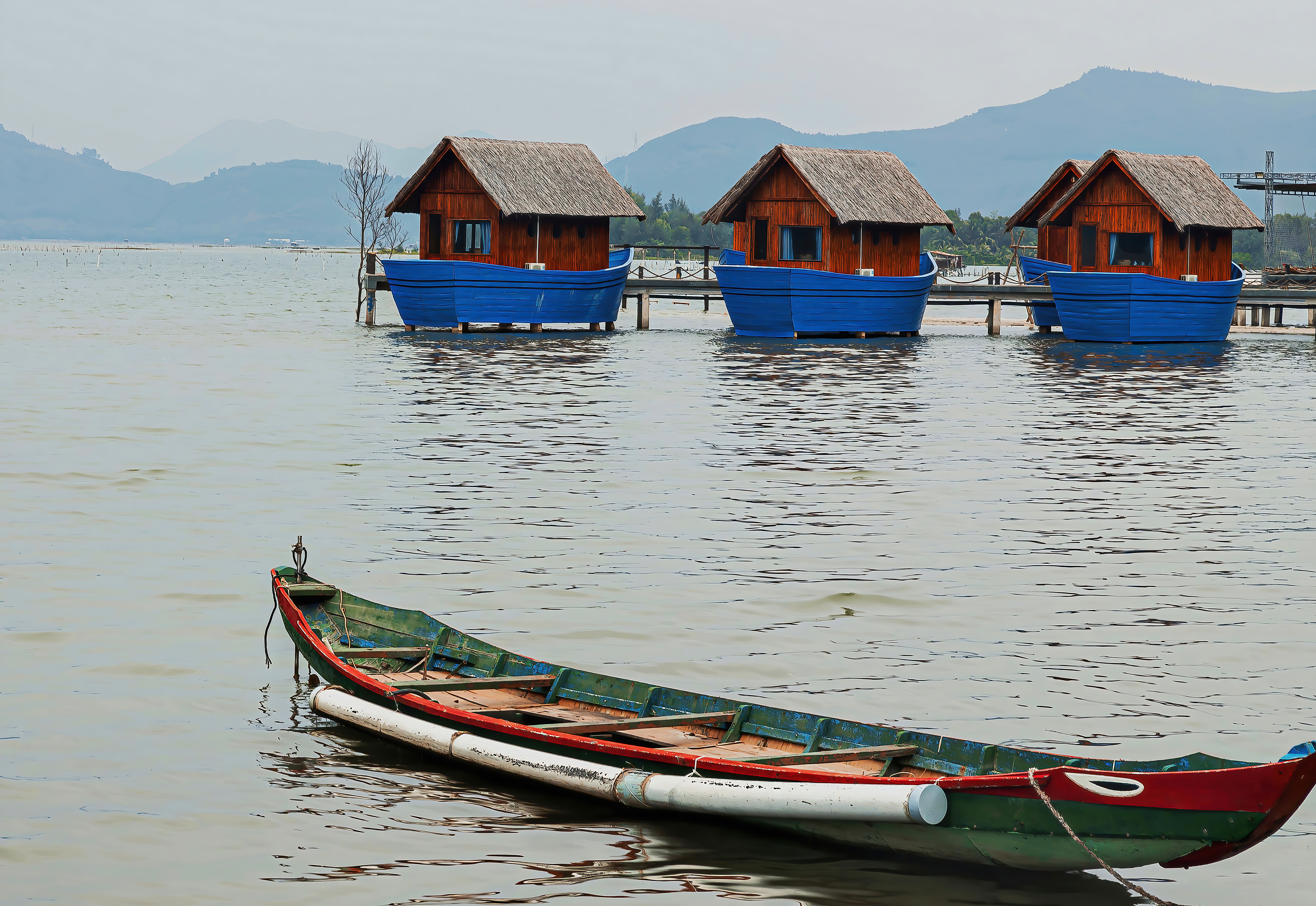 Wooden Boat on the Lake near Wooden Houses · Free Stock Photo