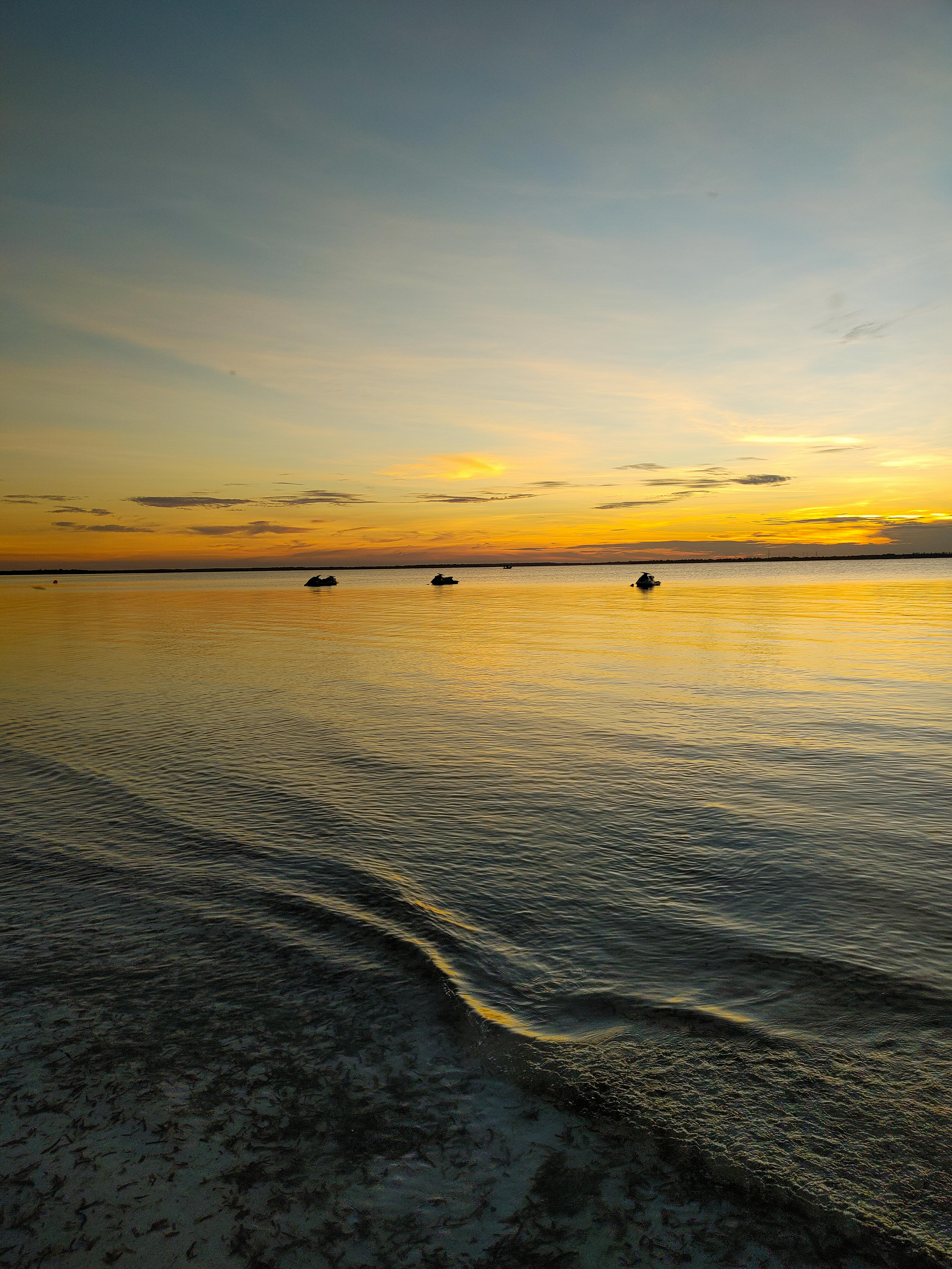 Serene sunset over calm waters at Michamvi Kae, Tanzania, capturing the peaceful evening mood.