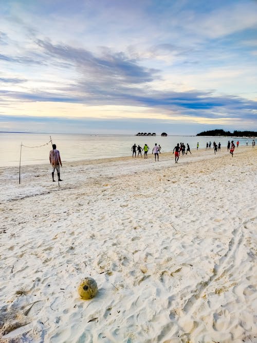 People Playing Soccer on Beach