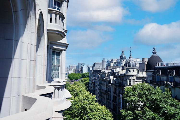 View From Balcony On Old Historic Buildings And Green City