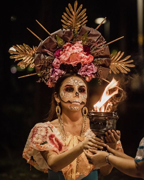 Free Traditional Dia de los Muertos portrait with painted face and torch at night. Stock Photo