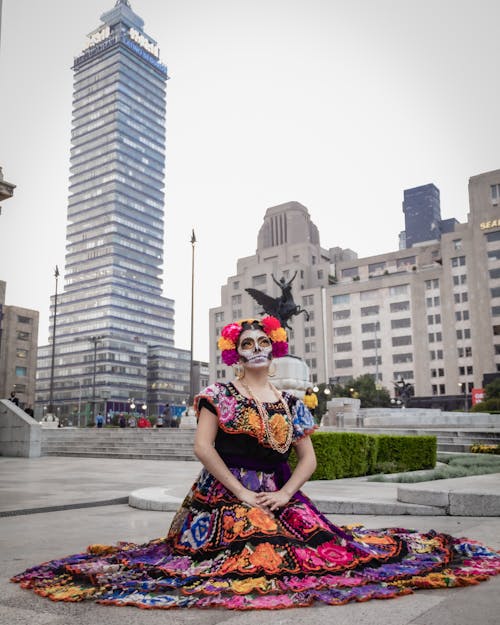 Catrina in Colorful Dress Kneeling on Square in Mexico City
