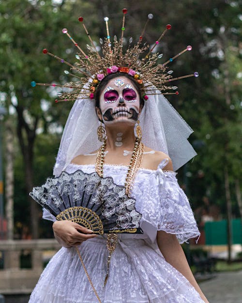 A Woman in White Dress Holding a Hand Fan