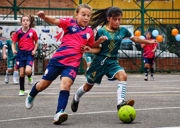 Children Playing Soccer On Field