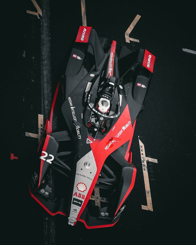 Photograph Of A Colorful Formula E Racing Car Similar To A Formula 1 Car Racing On A Track In Mexico City