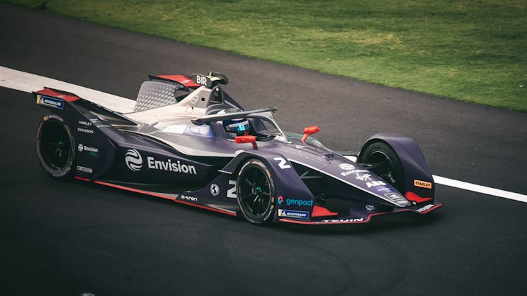 Photograph Of A Colorful Formula E Racing Car Similar To A Formula 1 Car Racing On A Track In Mexico City