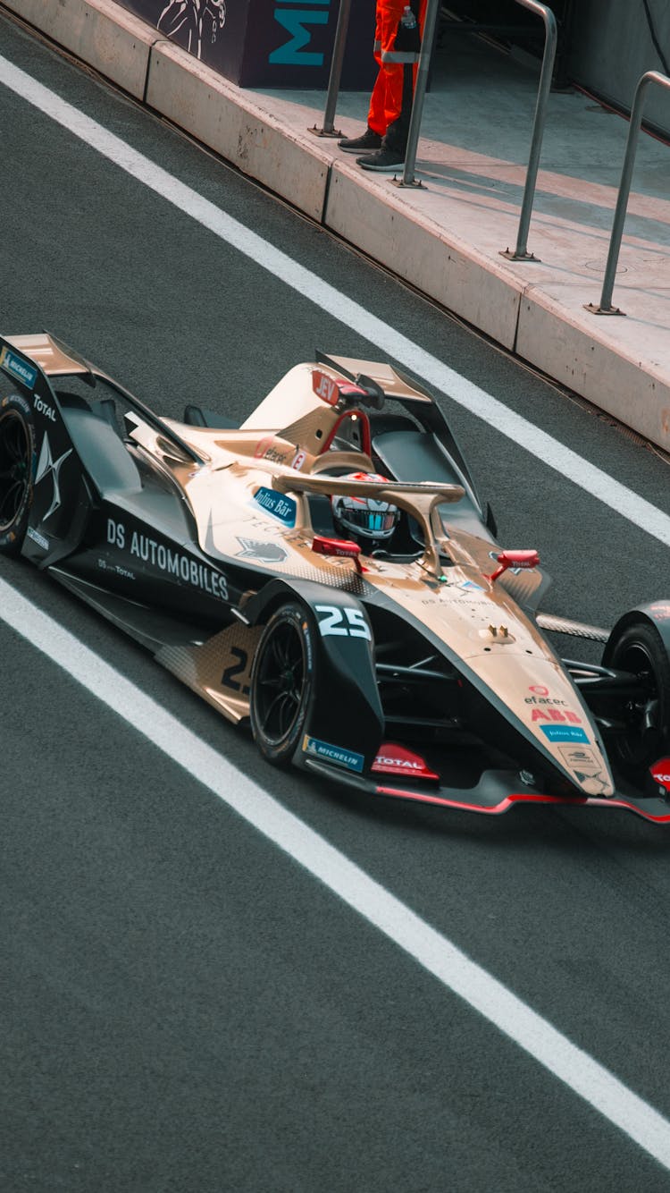 Photograph Of A Colorful Formula E Racing Car Similar To A Formula 1 Car Racing On A Track In Mexico City