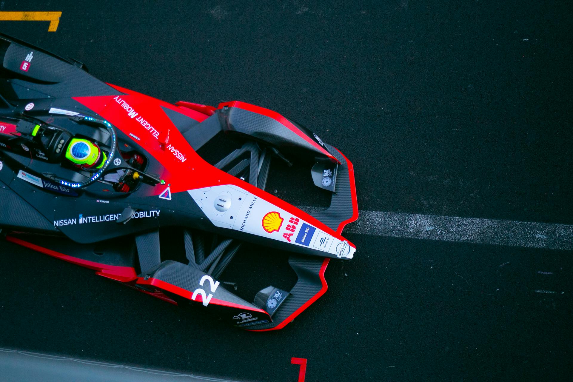 Photograph of a colorful Formula E racing car similar to a Formula 1 car racing on a track in Mexico City