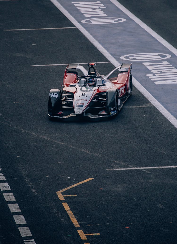 Photograph Of A Colorful Formula E Racing Car Similar To A Formula 1 Car Racing On A Track In Mexico City