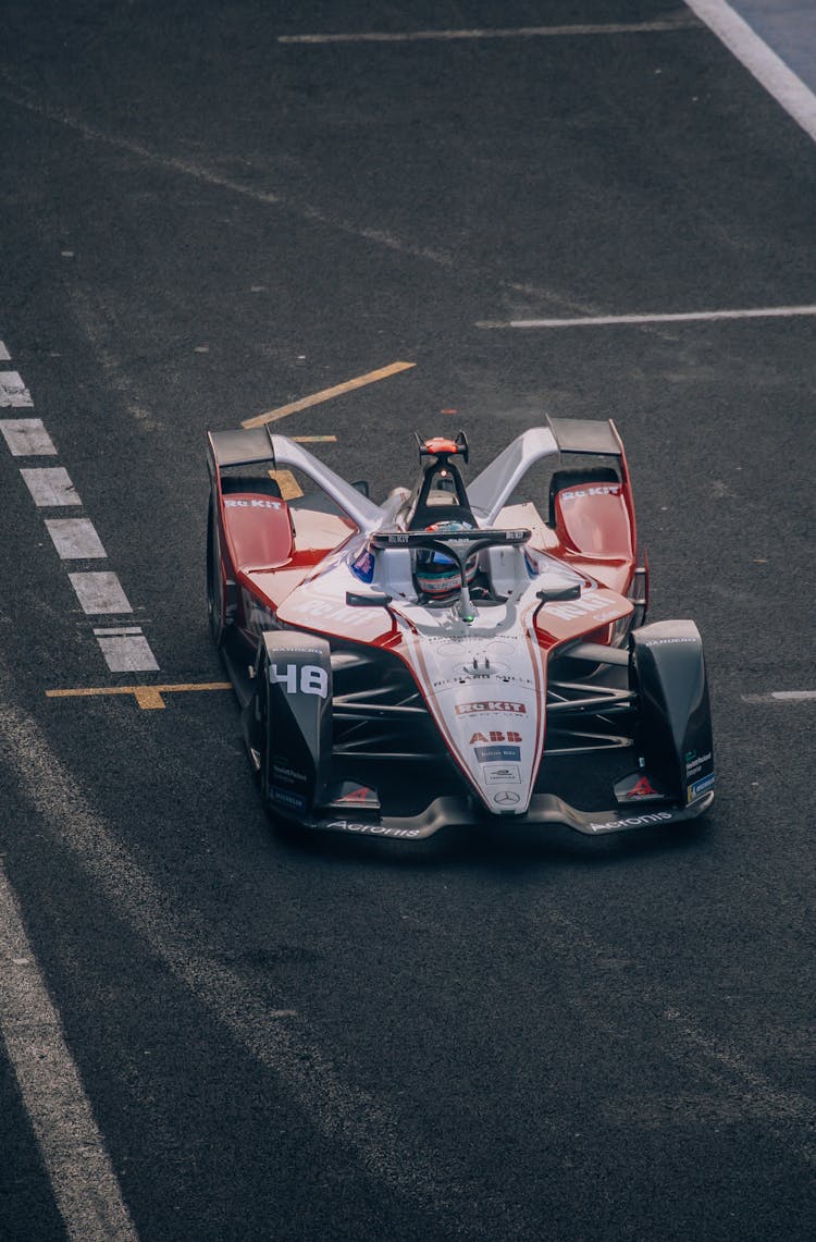 Photograph Of A Colorful Formula E Racing Car Similar To A Formula 1 Car Racing On A Track In Mexico City