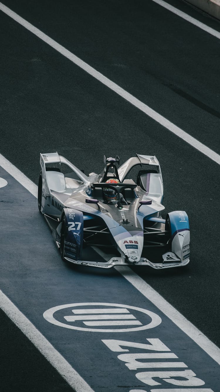 Photograph Of A Colorful Formula E Racing Car Similar To A Formula 1 Car Racing On A Track In Mexico City