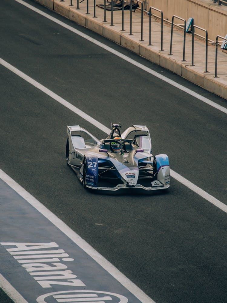 Photograph Of A Colorful Formula E Racing Car Similar To A Formula 1 Car Racing On A Track In Mexico City